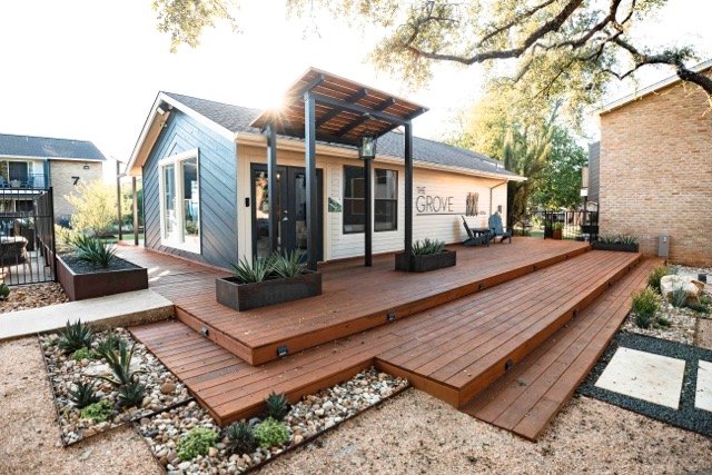 Raised wood deck and steps in front of a small clubhouse