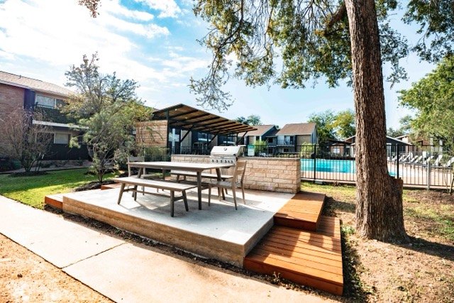 Picnic deck beside the pool under mature oak trees