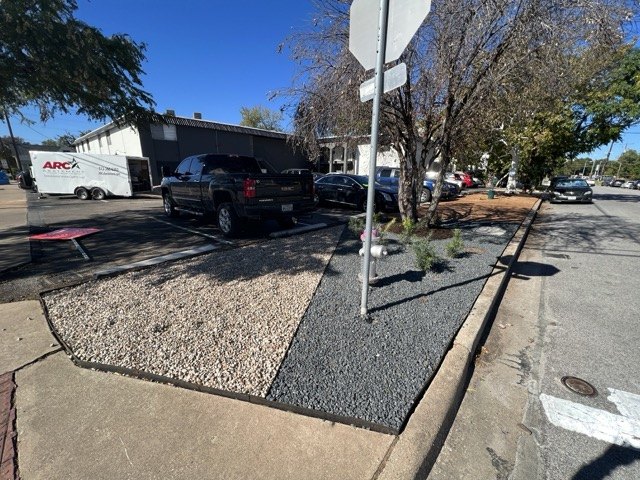 Xeriscaped parking-lot island with decomposed granite