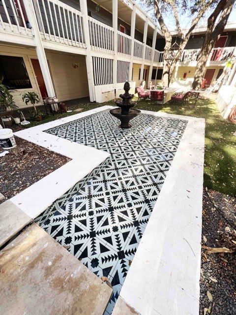 Fountain courtyard with patterned tile and white border