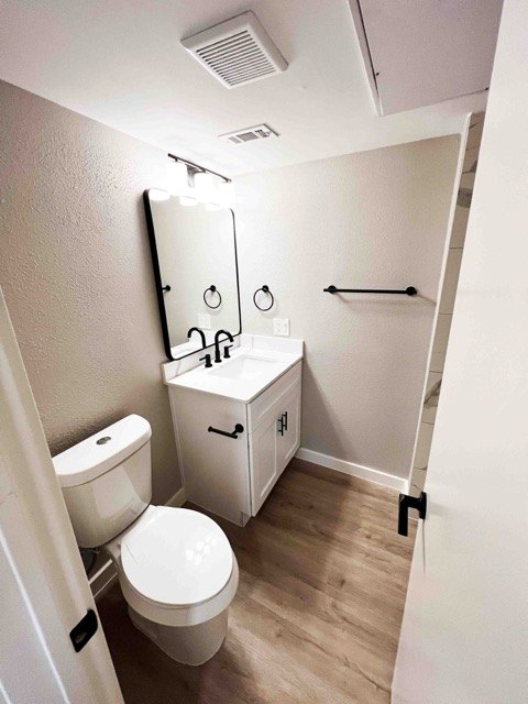 Bathroom with a white vanity and black hardware