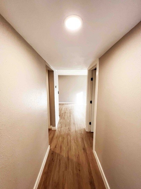 Long hallway with new flooring and paint